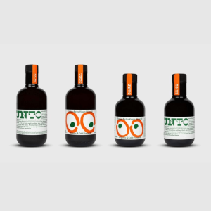 UNTO olive oils's packaging design includes two olives surrounded by large oval patterns resembling a pair of watchful eyes.